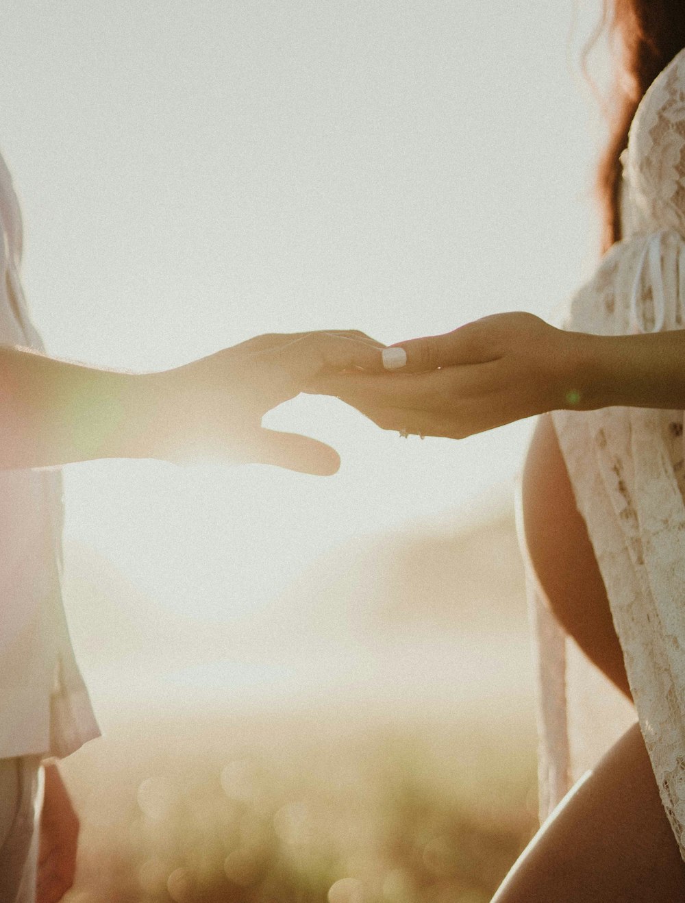 a close up of a person holding another person's hand