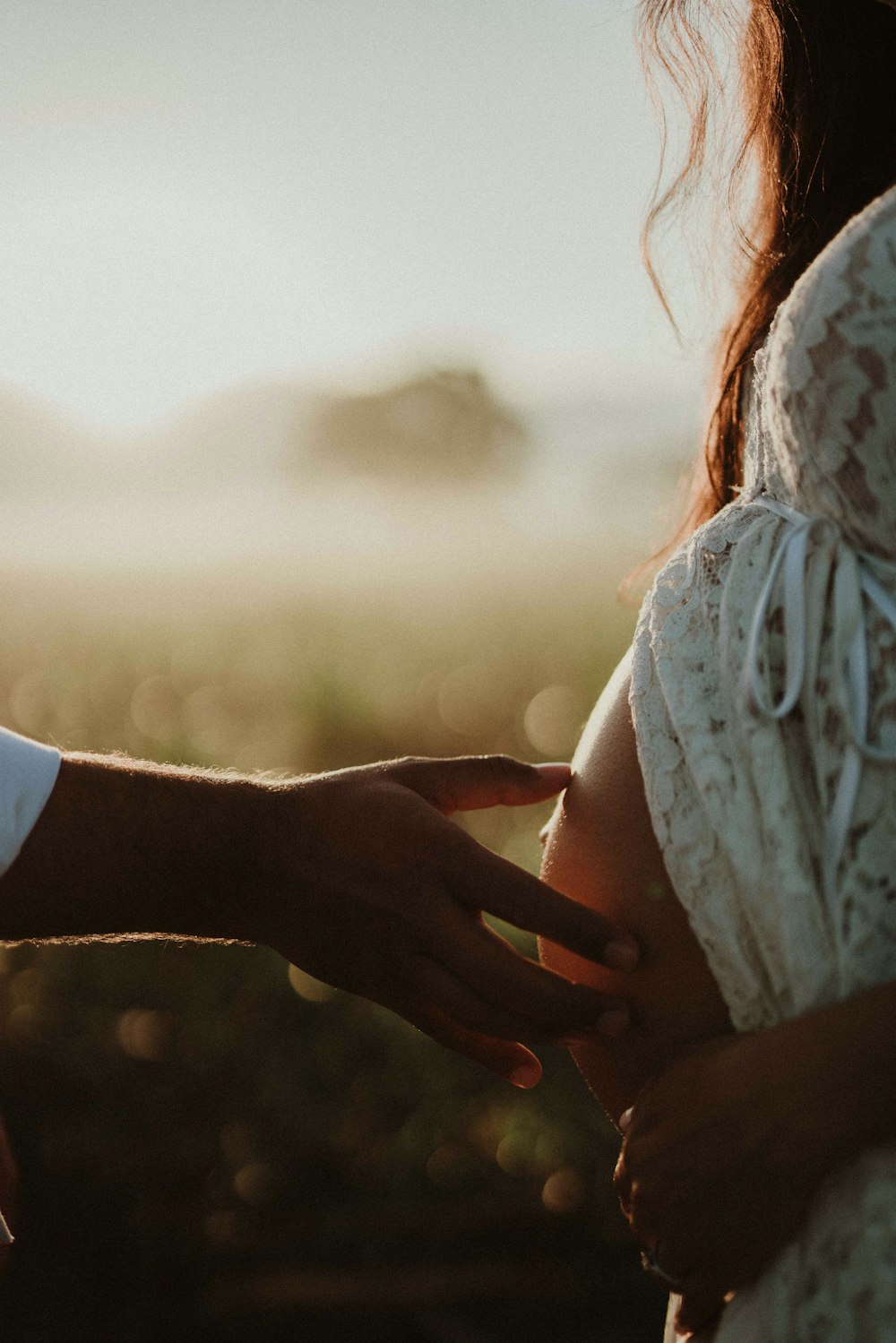 a close up of a person touching another person's hand