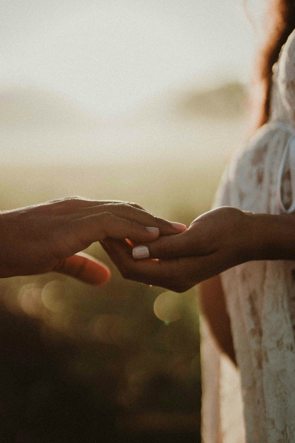 a close up of two people holding hands