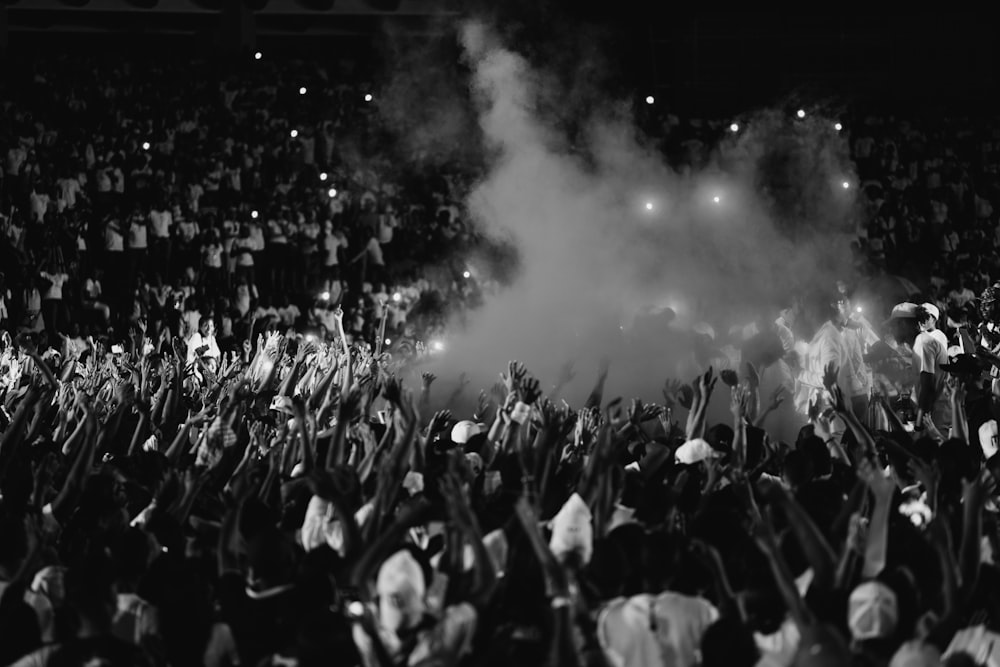 a black and white photo of a crowd at a concert