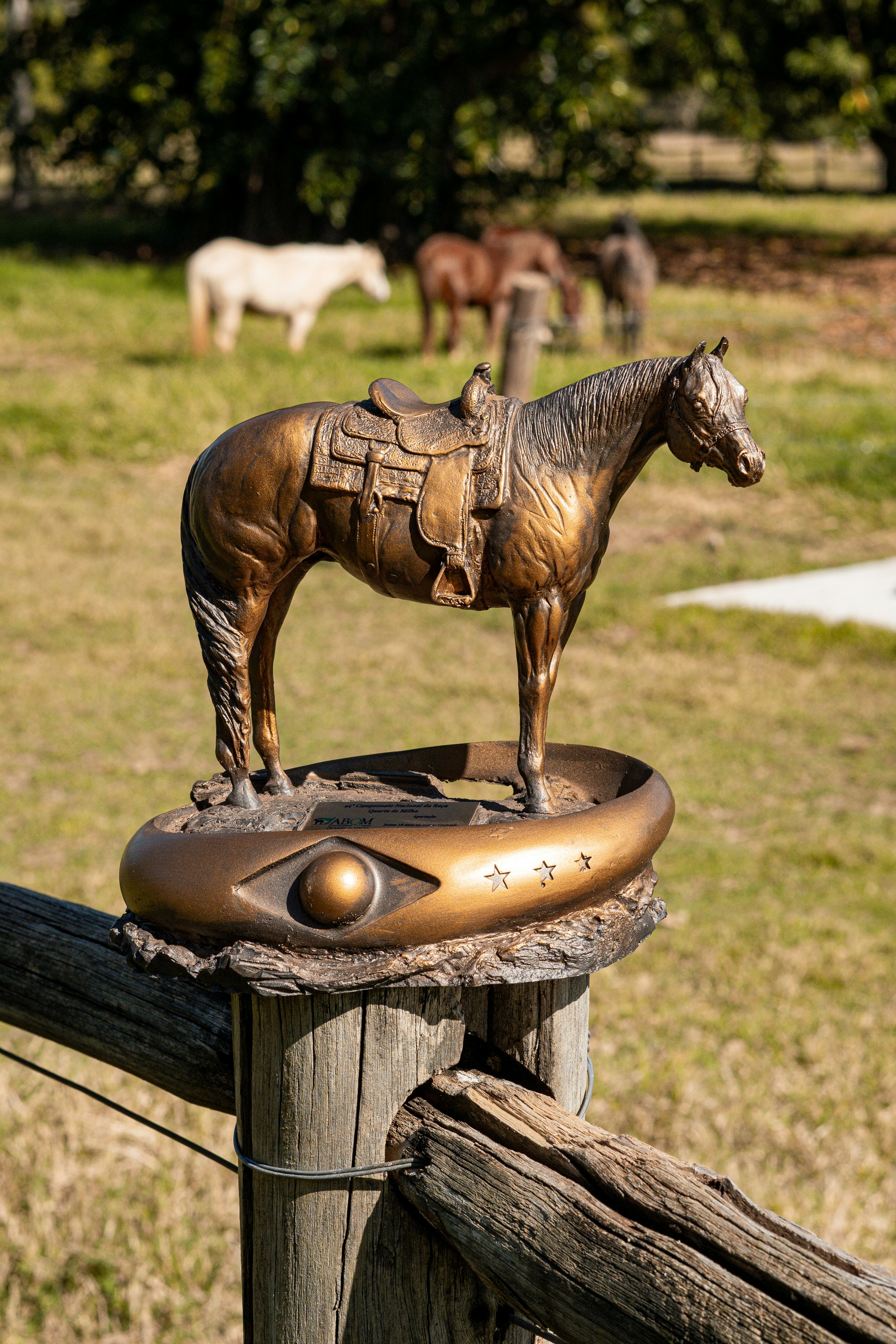 a statue of a horse on top of a wooden post