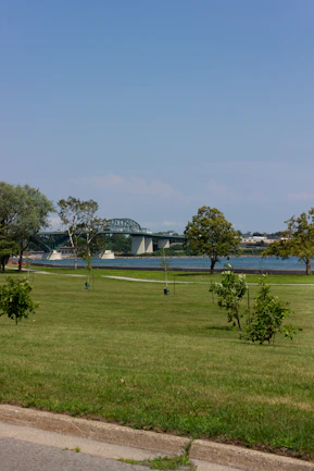 A panoramic view of the new community park under construction with locals helping plant trees.