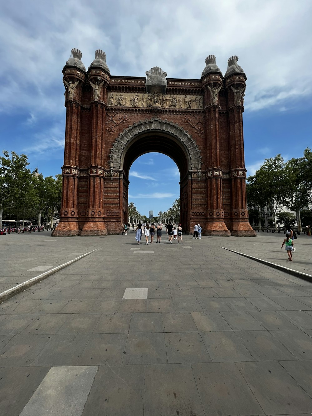 a group of people standing in front of a large arch