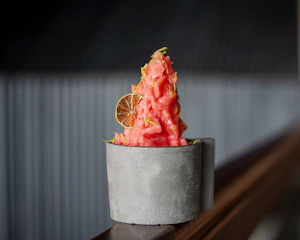 Colorful sorbet scoops in vibrant purple and pink hues served in minimalist black bowls.