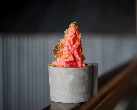 Minimalist display of sorbet cups with vibrant colors and simple garnishes.