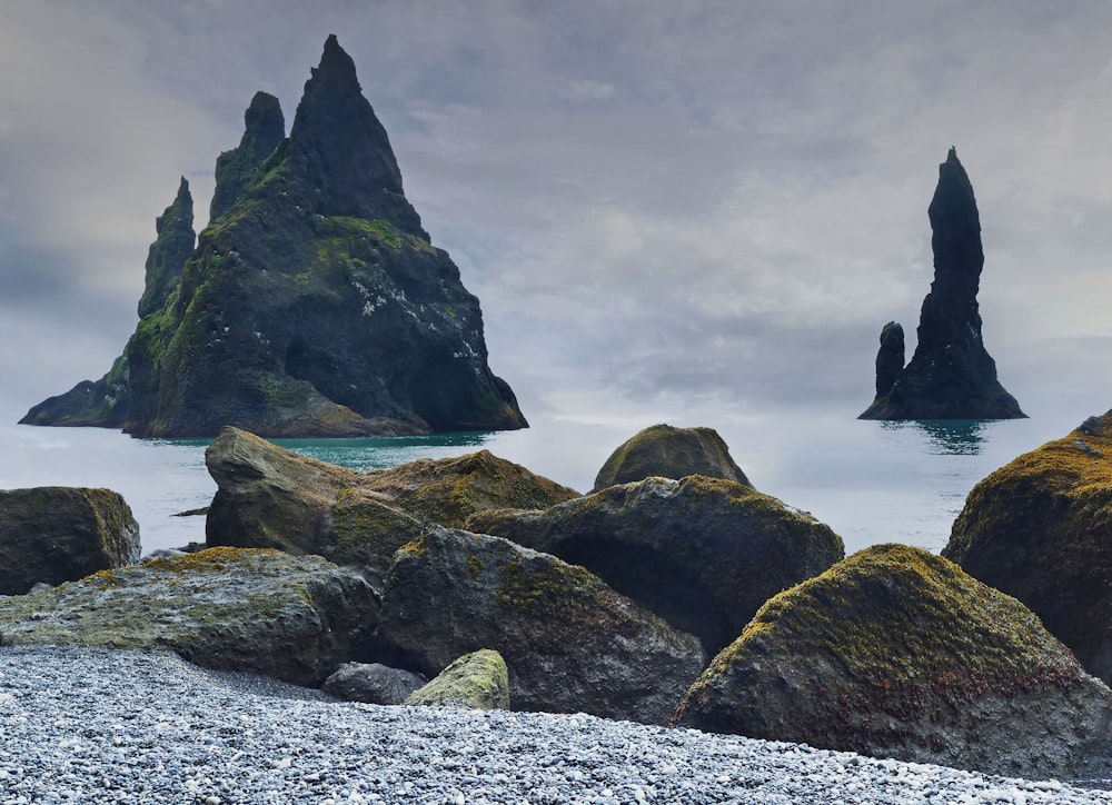 a group of rocks sitting on top of a beach