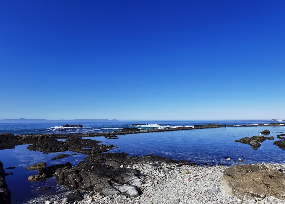 a large body of water surrounded by rocks