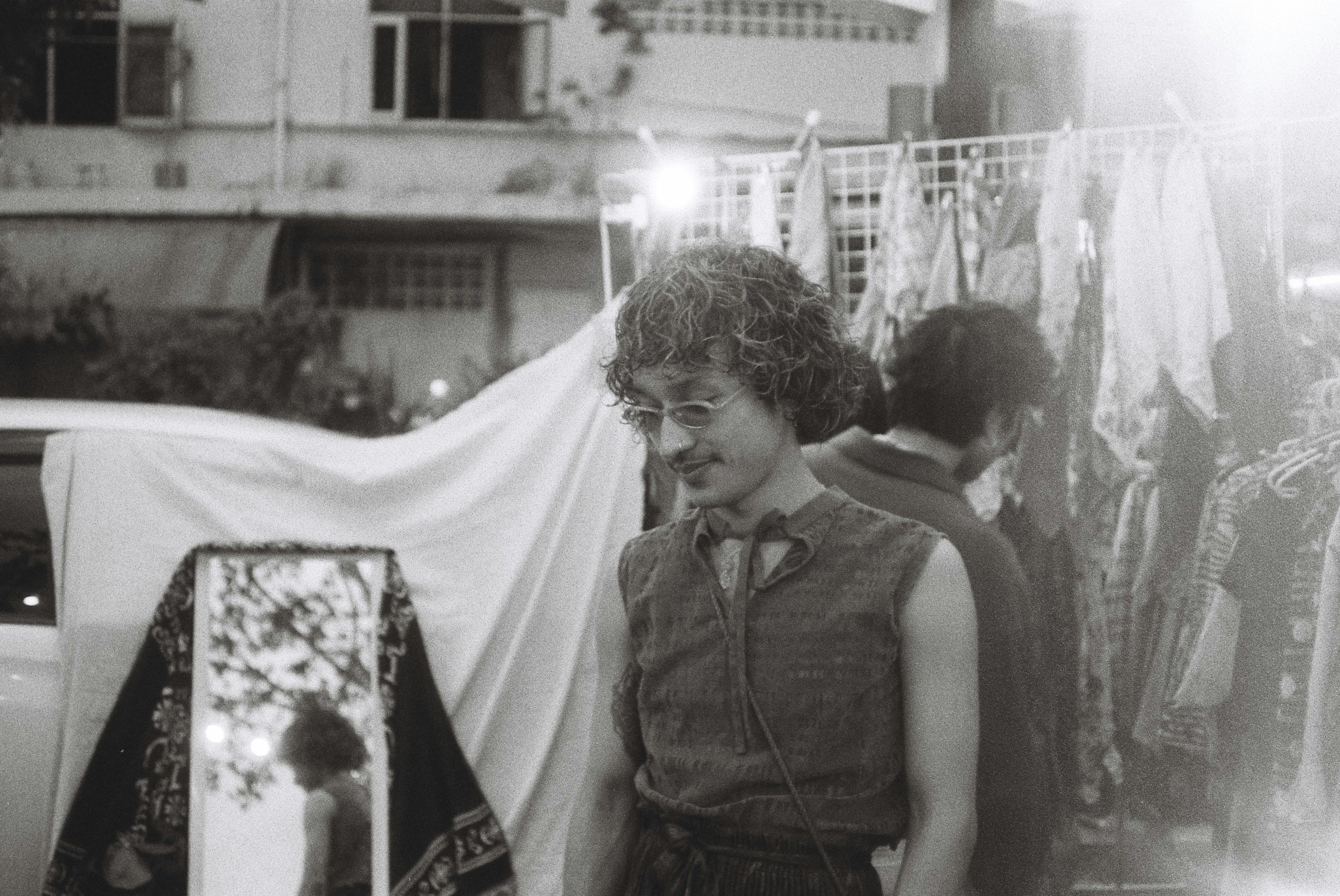 a man standing in front of a display of clothes