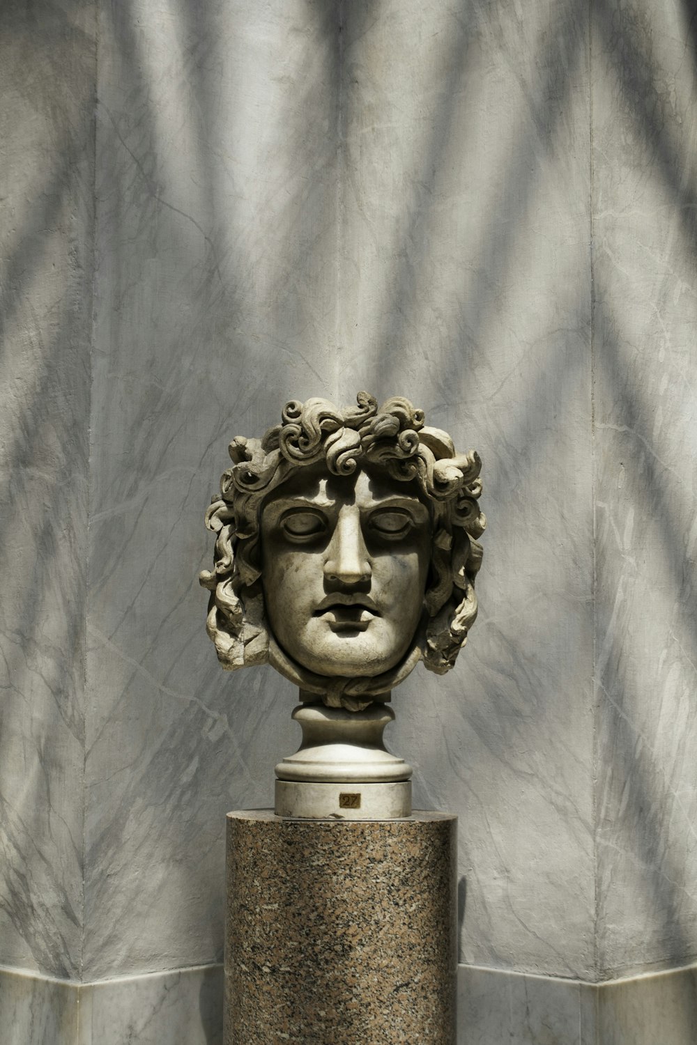 a statue of a woman's head on a pedestal