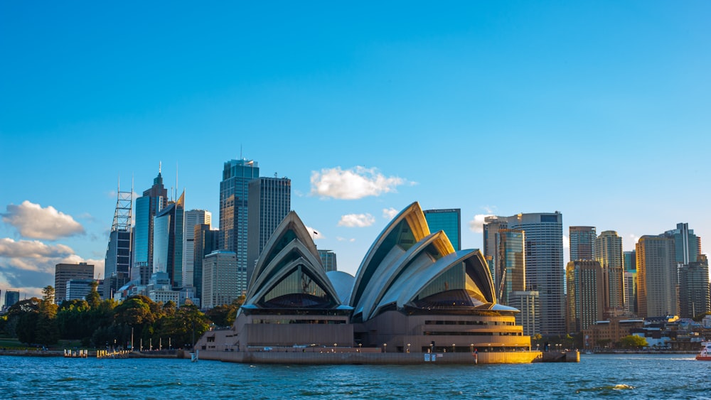 the sydney opera house in front of the city skyline