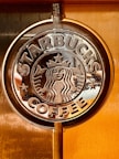 a close up of a starbucks sign on a door
