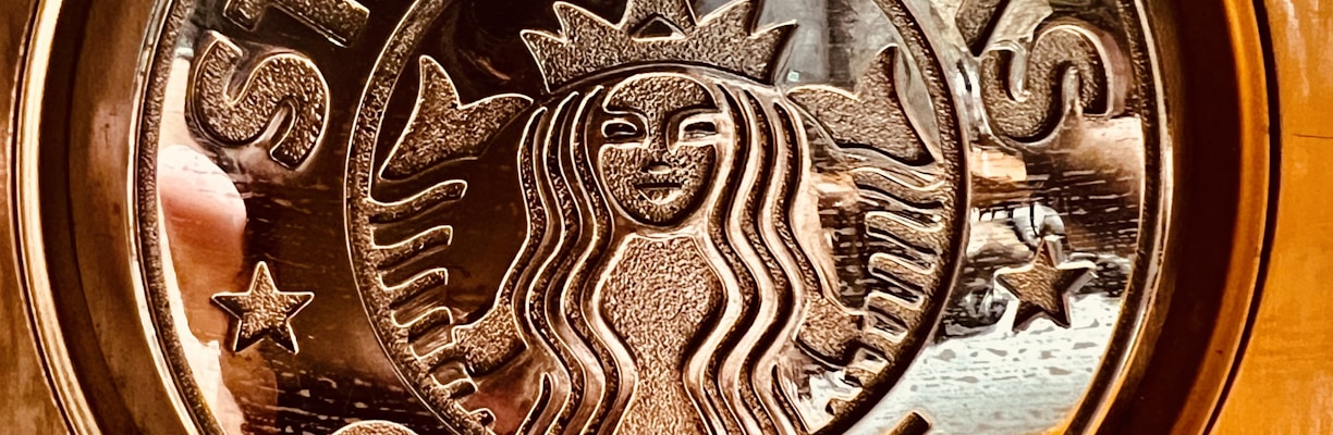 a close up of a starbucks sign on a door