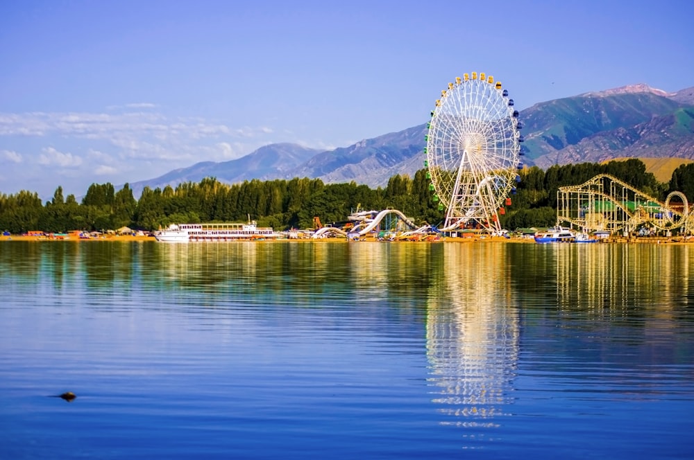 a ferris wheel sitting in the middle of a lake