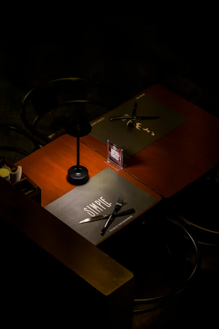 Close-up of a glowing QR menu displayed on a restaurant table under moody lighting.