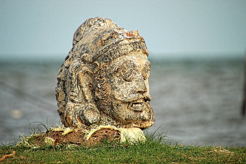 a stone statue of a man with a beard