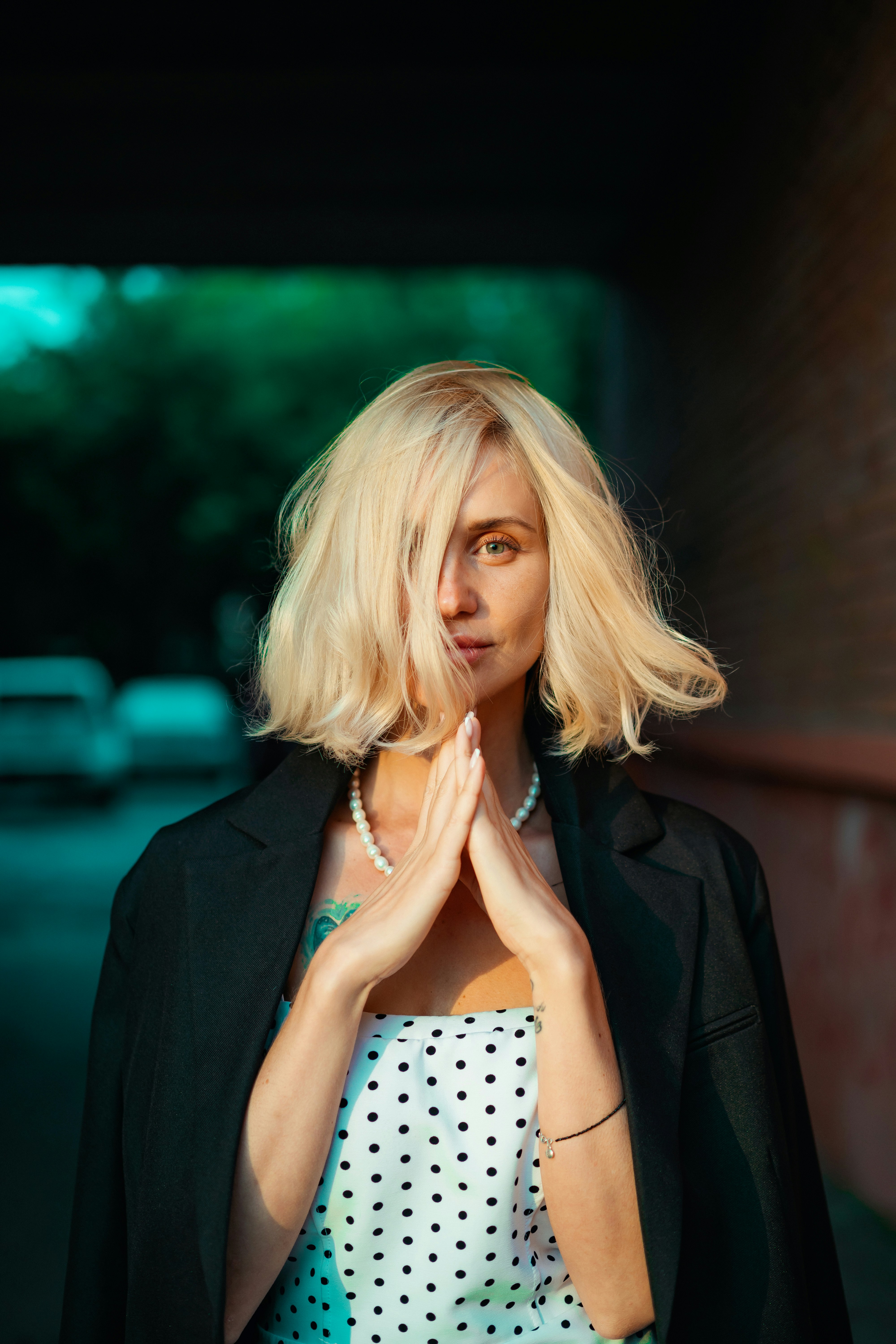 a woman with blonde hair and a black jacket