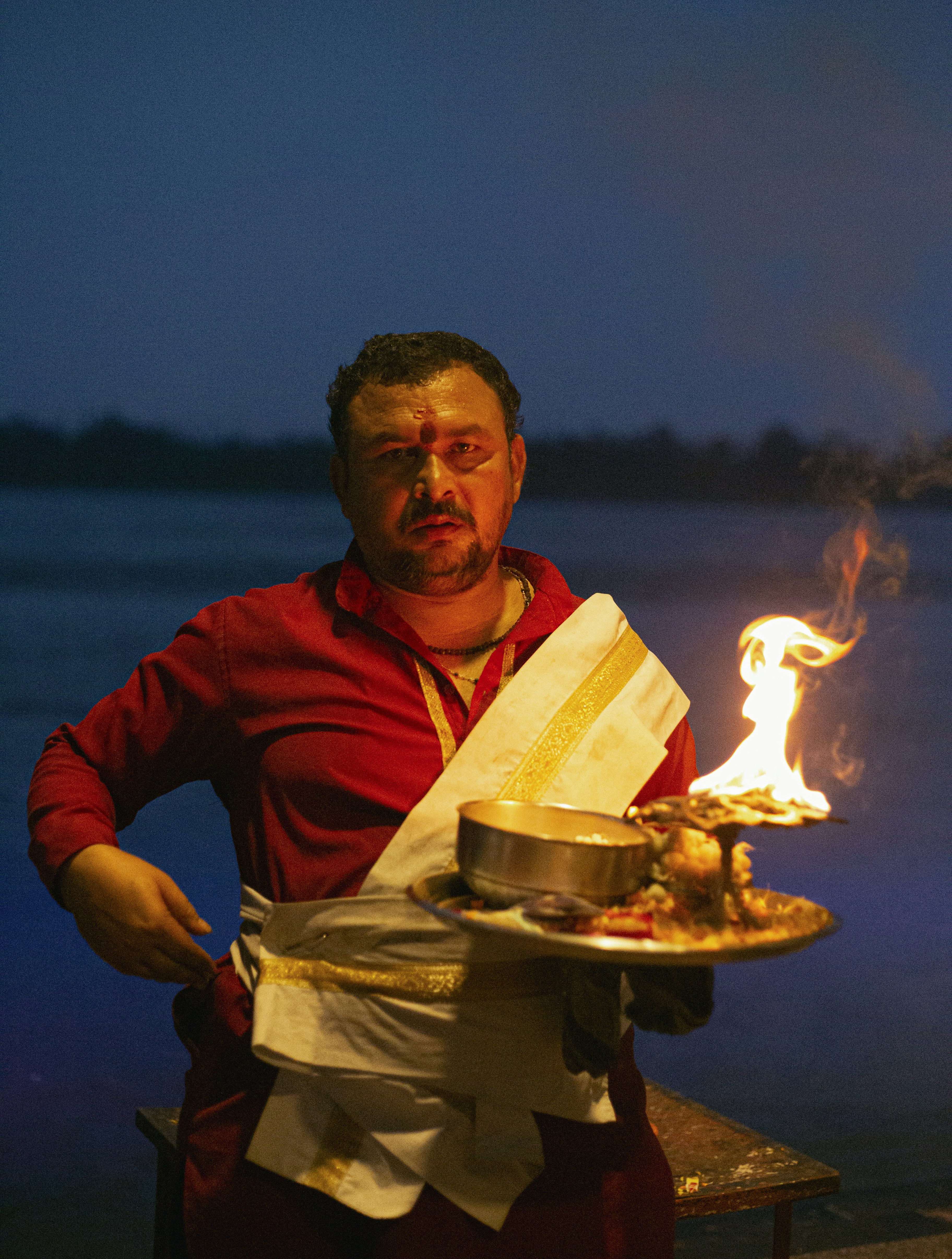 a man holding a plate with food on it