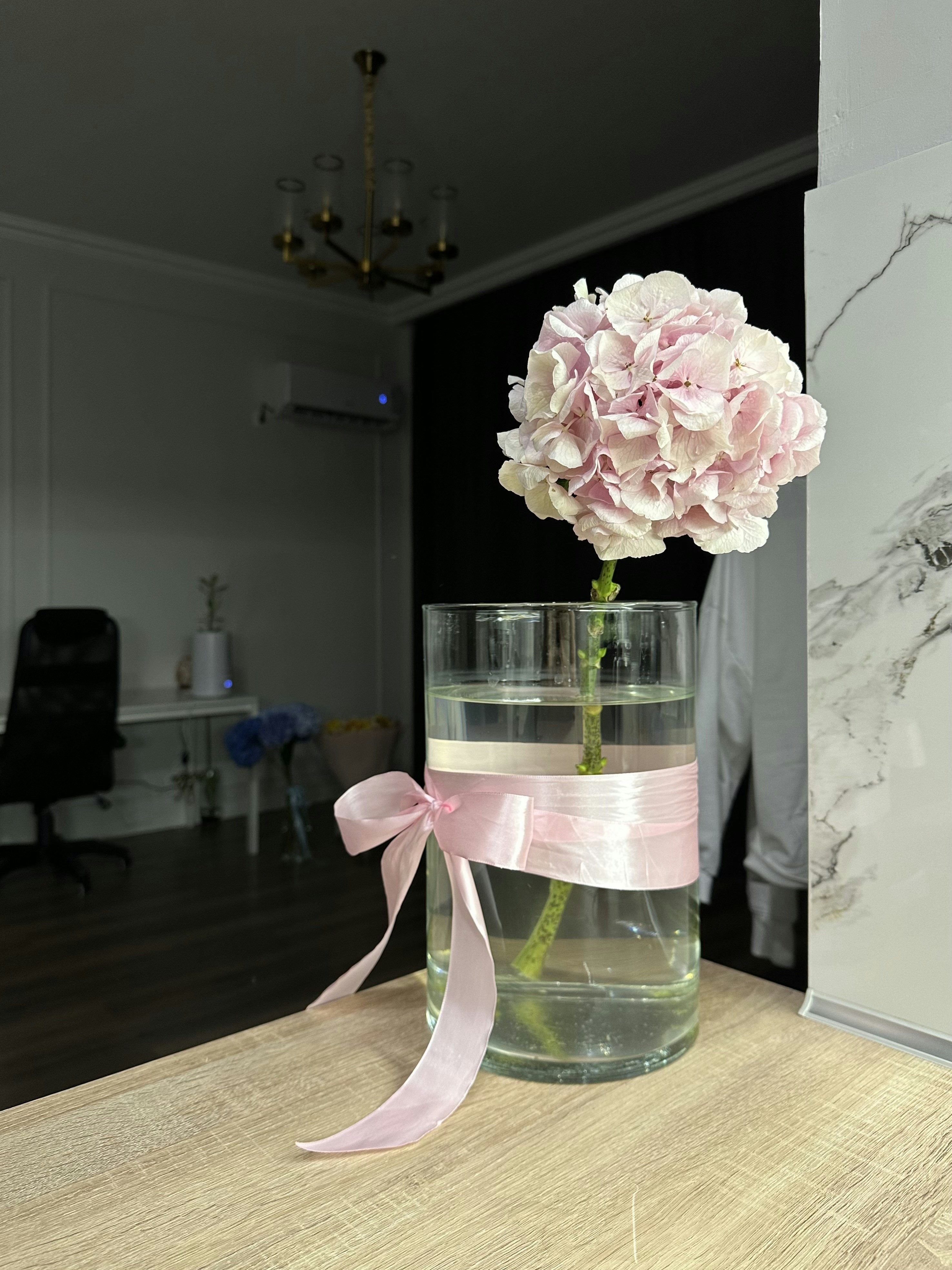 Handcrafted pink hair bow being made with ribbon on wooden table, soft natural lighting