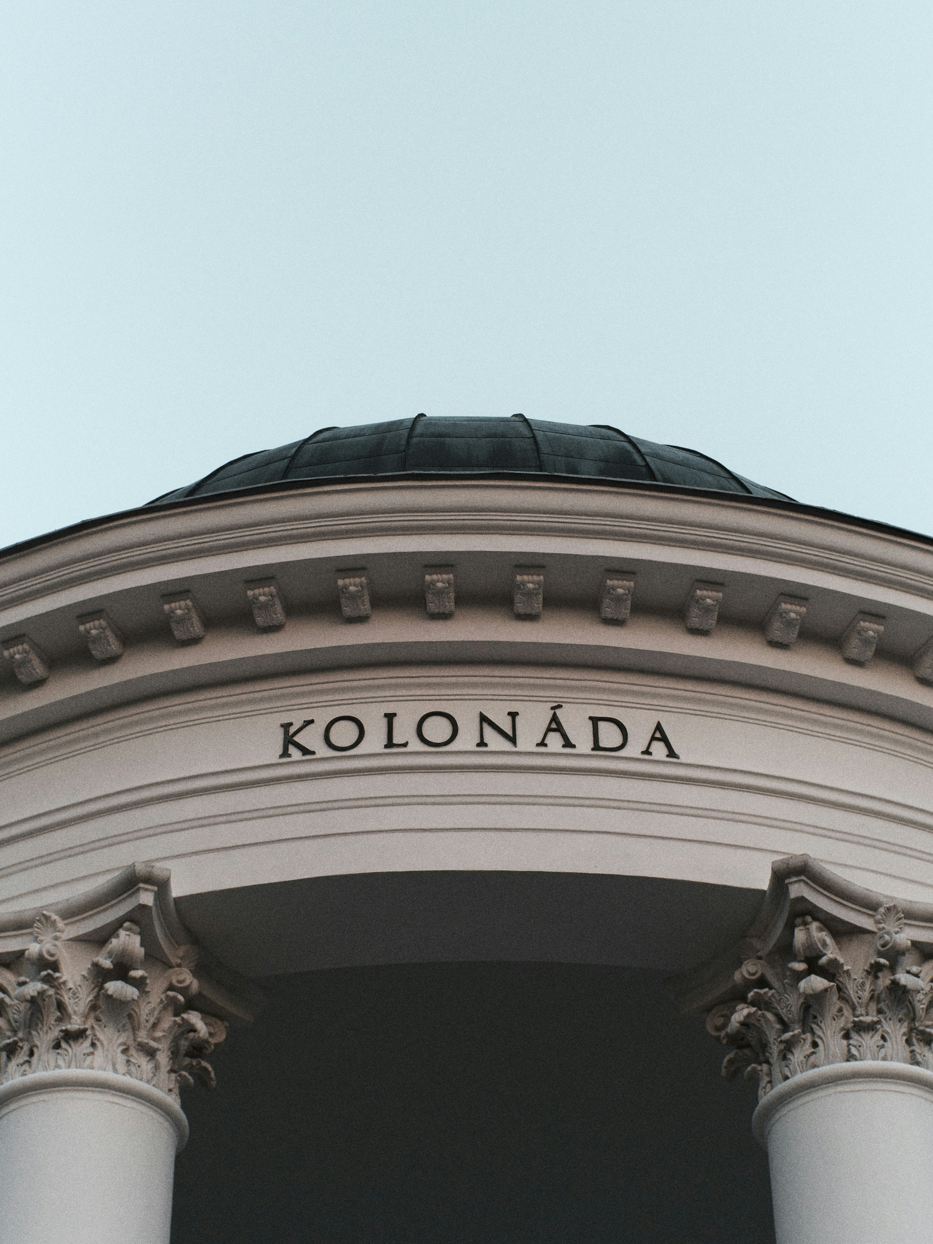 a large white building with a clock on it's side