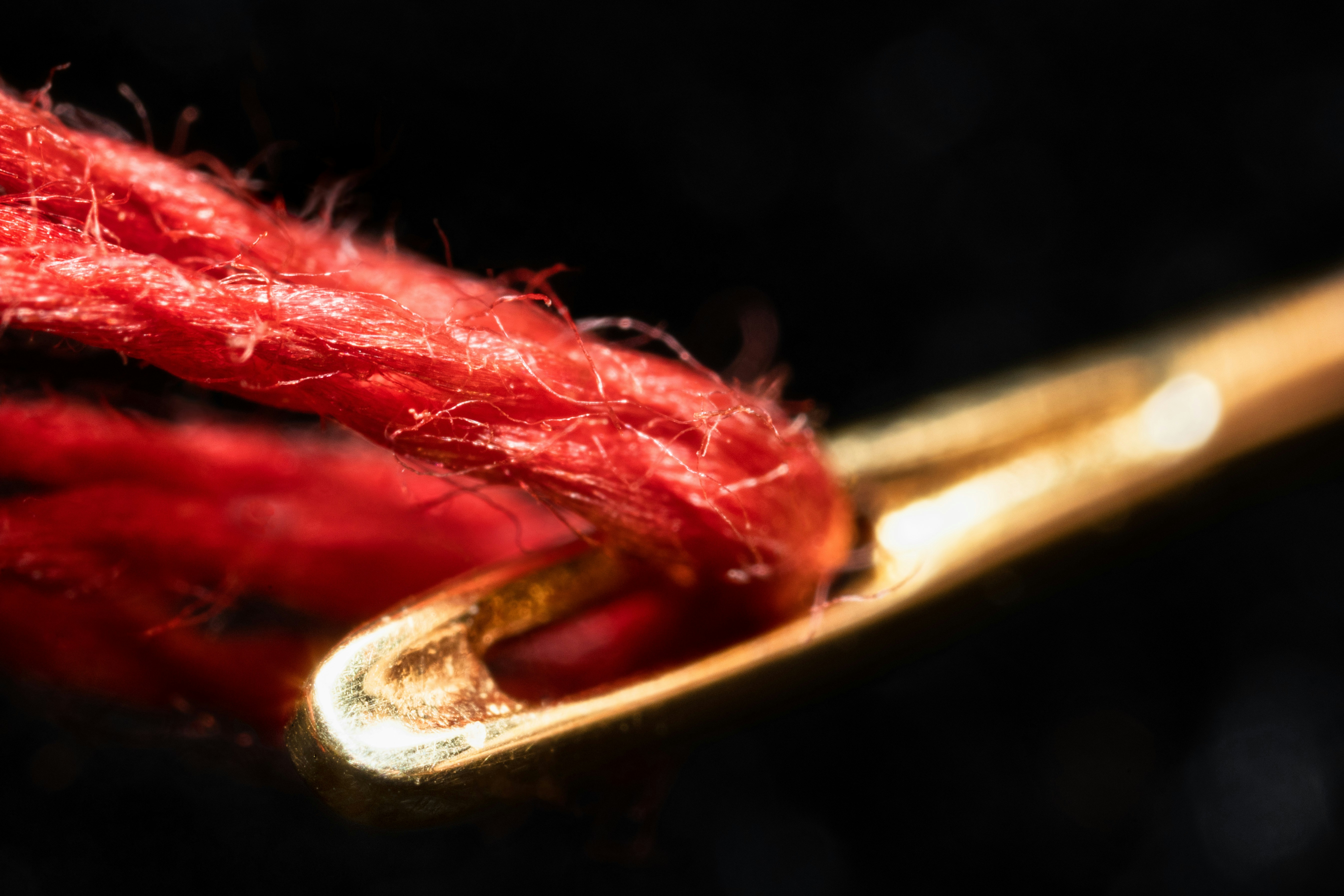 a close up of a red piece of yarn