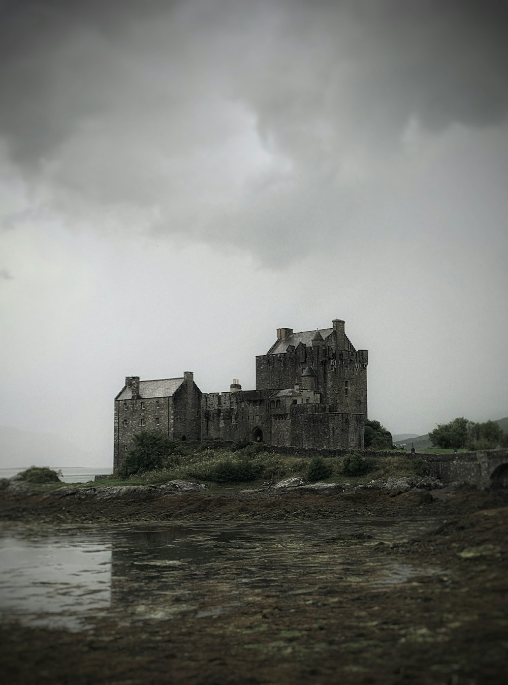 an old castle sitting on top of a small island