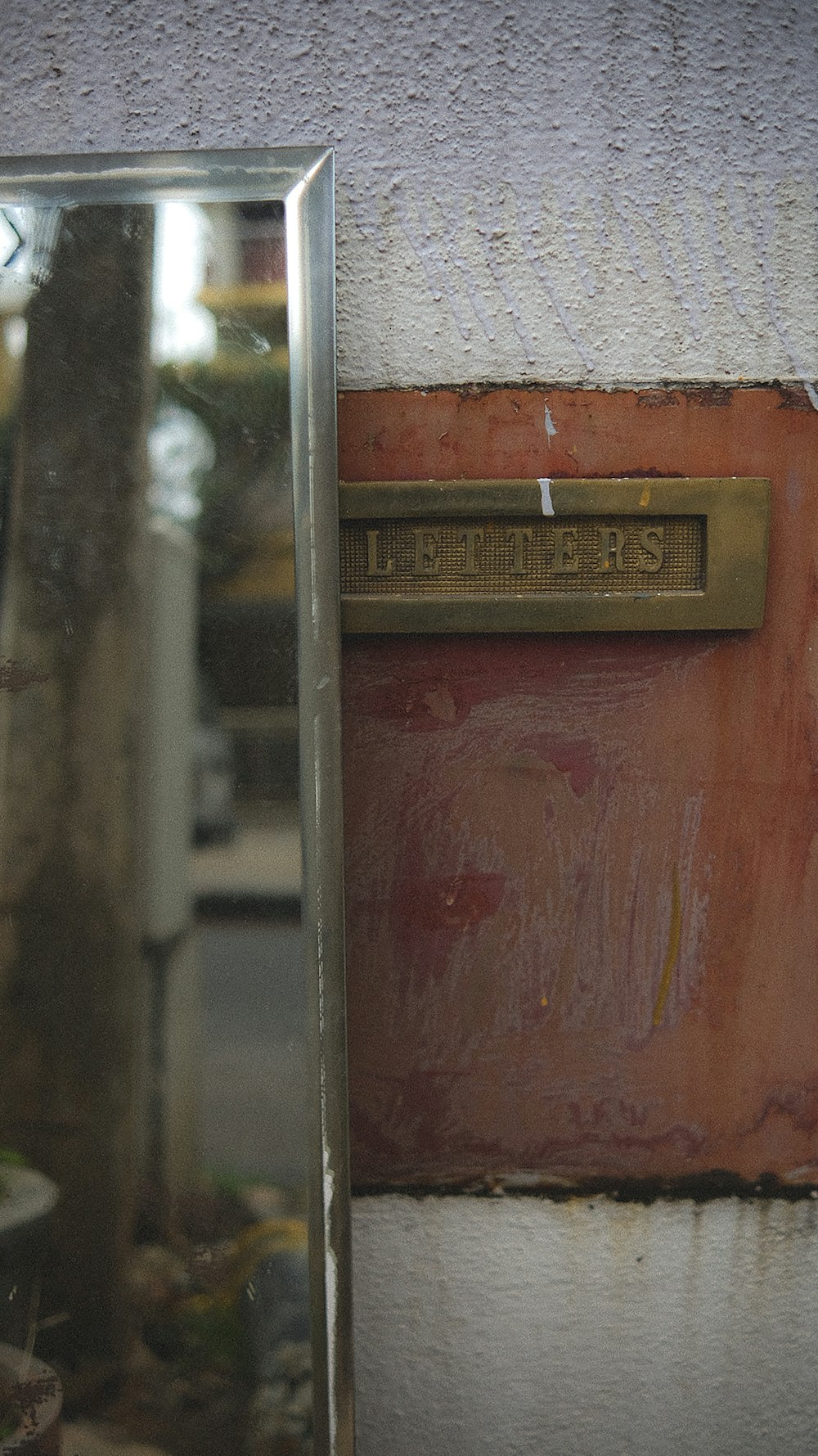 a mirror sitting on the side of a wall