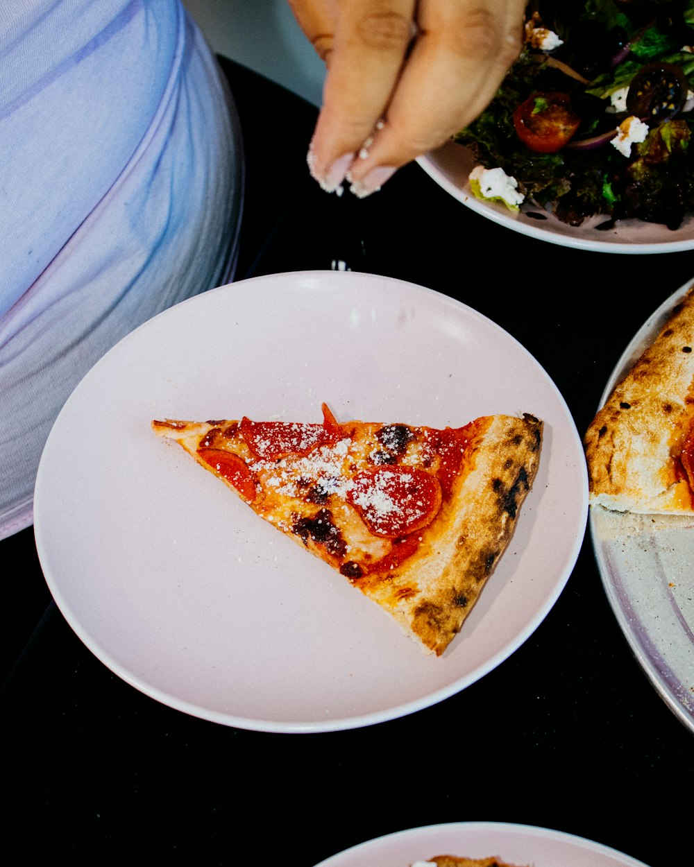 a slice of pizza on a white plate