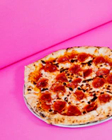 Before and after images of a pizza showcasing enhanced colors and lighting.