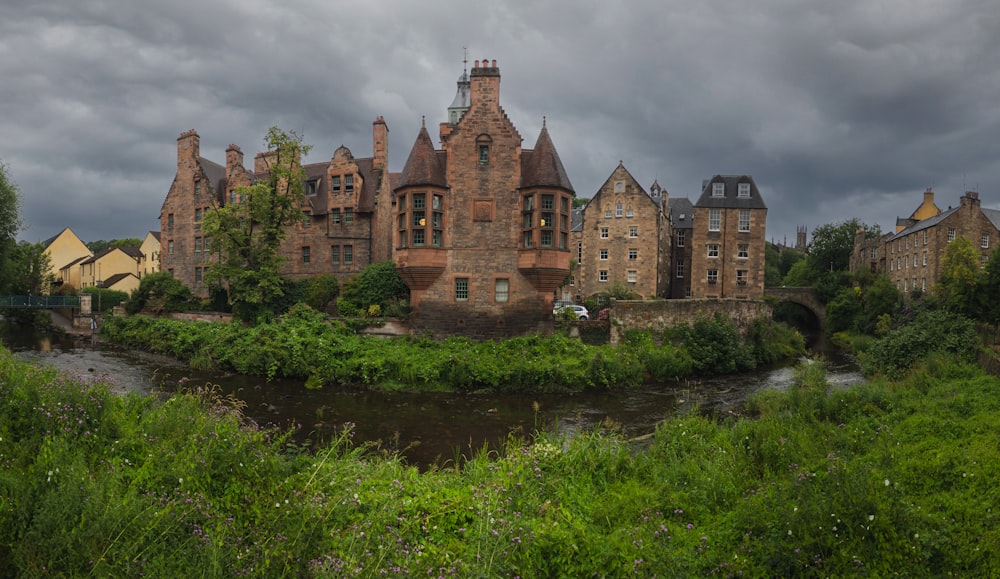 a castle like building sitting on top of a lush green field