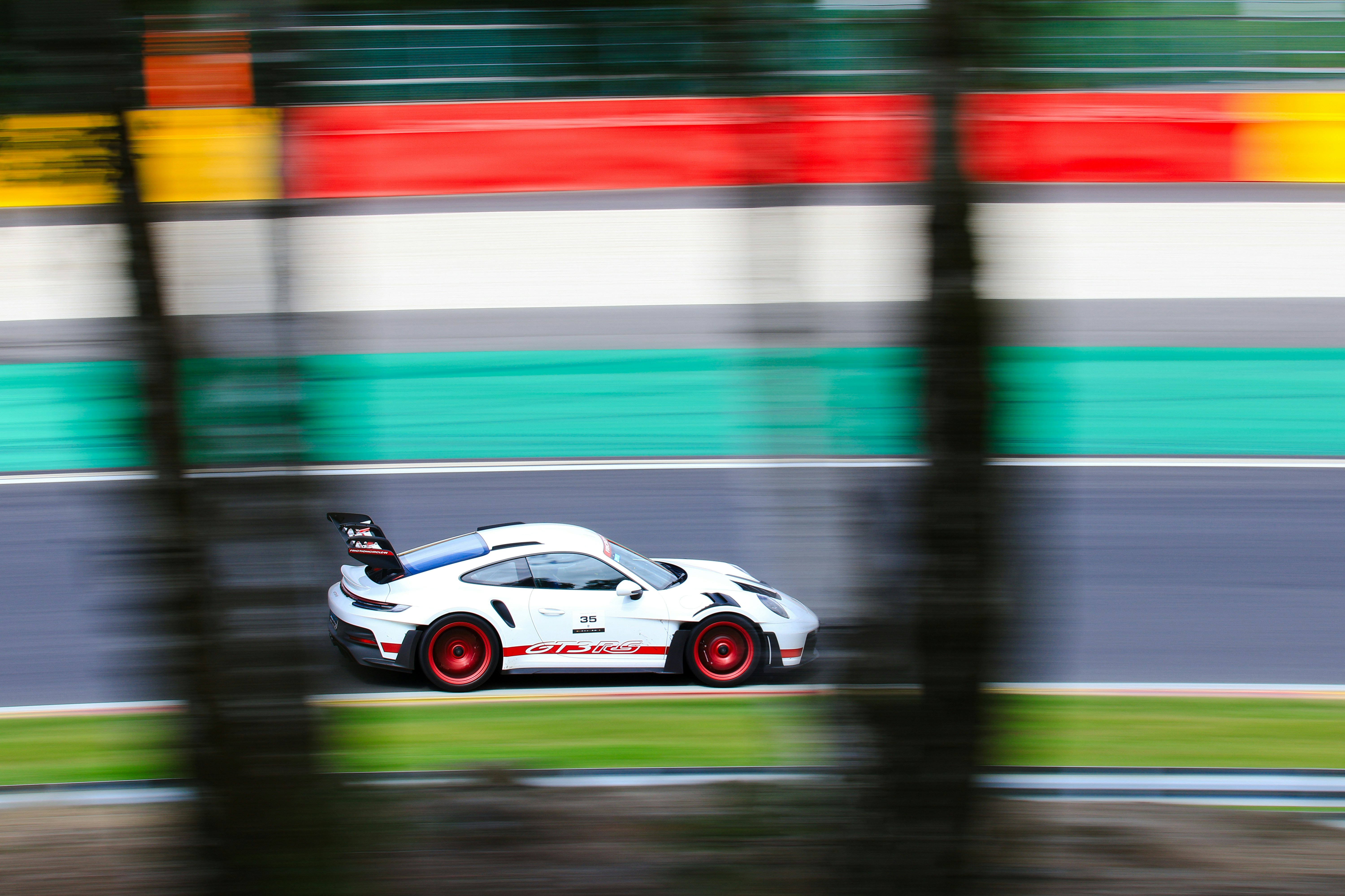 A white sports car driving down a race track photo – Free Spa ...