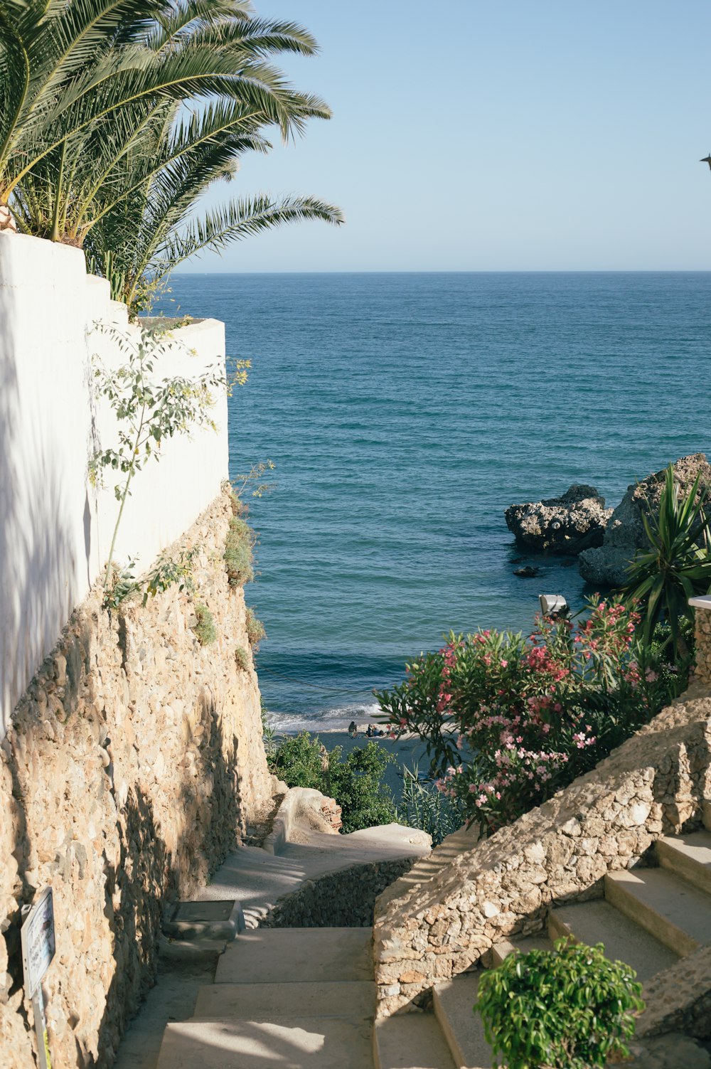 a view of the ocean from a stone staircase