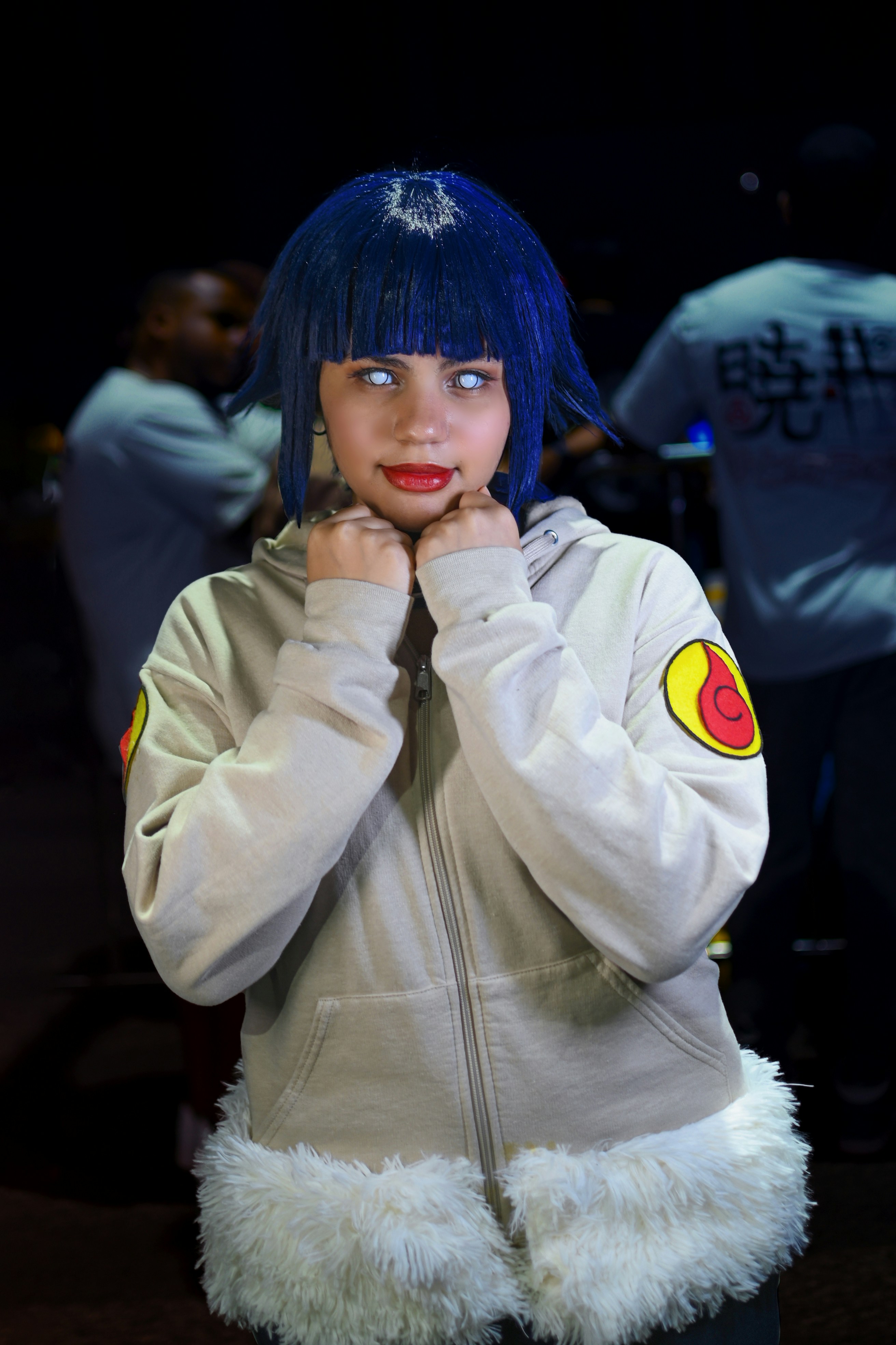 Seorang wanita berambut biru mengenakan jaket putih