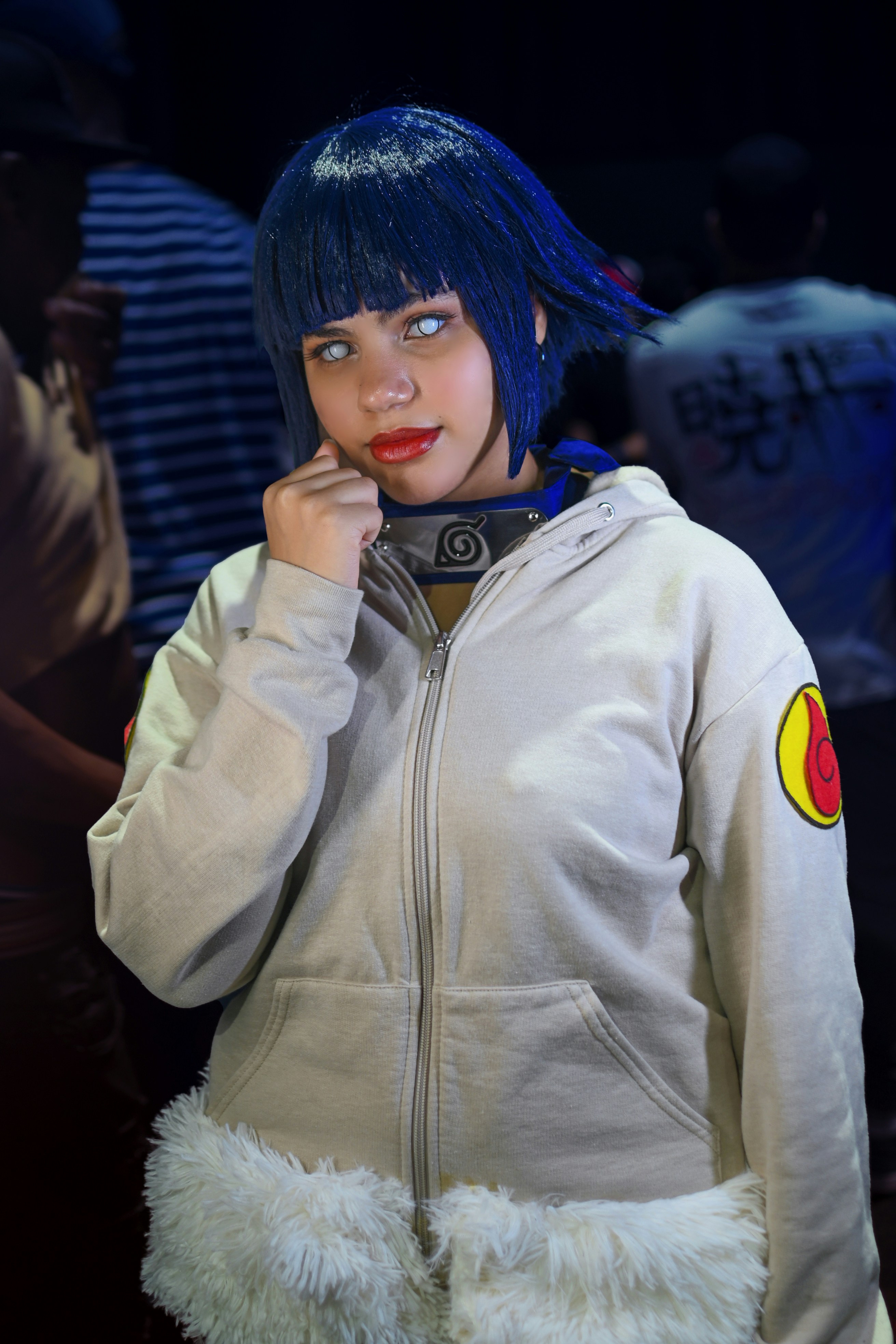 Seorang wanita berambut biru mengenakan jaket putih