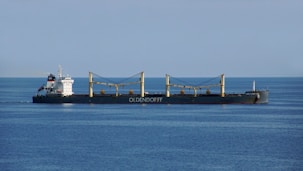 a large cargo ship in the middle of the ocean