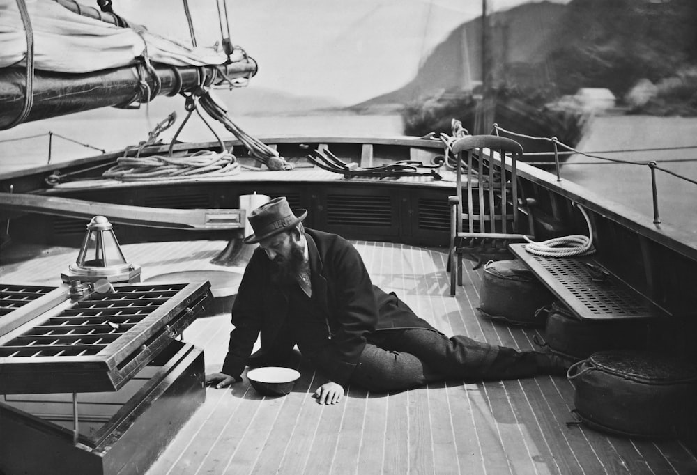 a man sitting on the deck of a boat