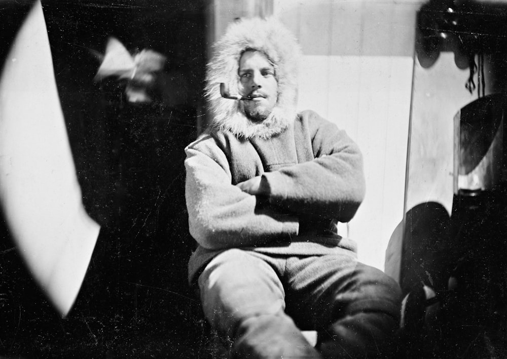 a man sitting on a chair wearing a furry hat