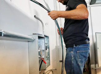 Certified technician installing a modern furnace inside a residential basement.