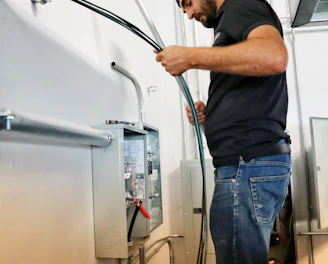 Technician installing a new water heater in a residential bathroom.