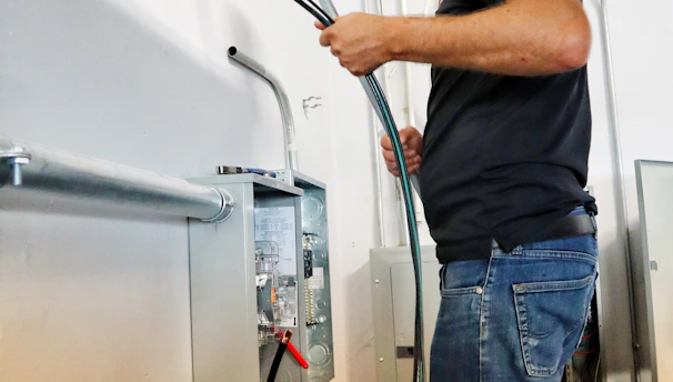 Certified technician installing a modern furnace inside a residential basement.
