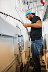 An electrician working on a residential electrical panel.