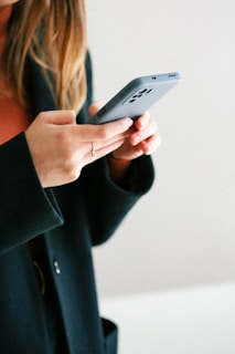 a woman holding a cell phone in her hands