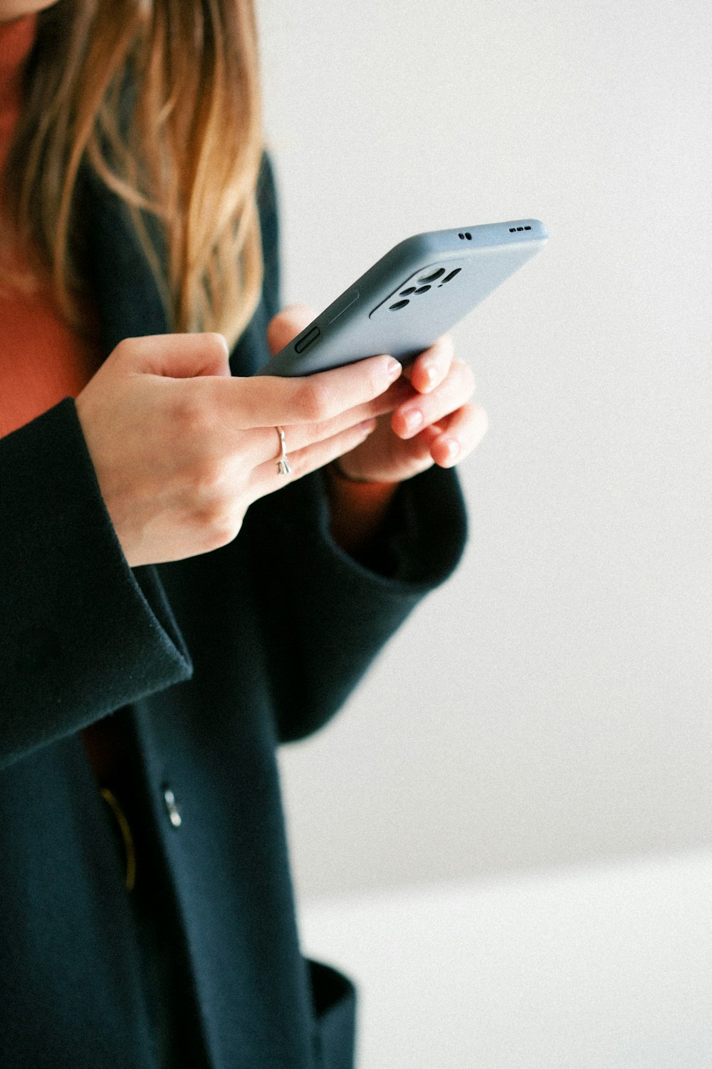 a woman holding a cell phone in her hands