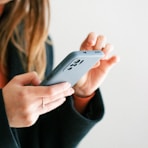 a woman holding a cell phone in her hands