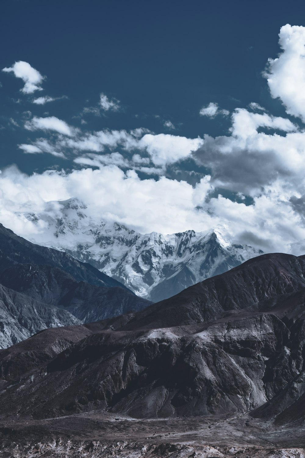 a view of a mountain range with clouds in the sky