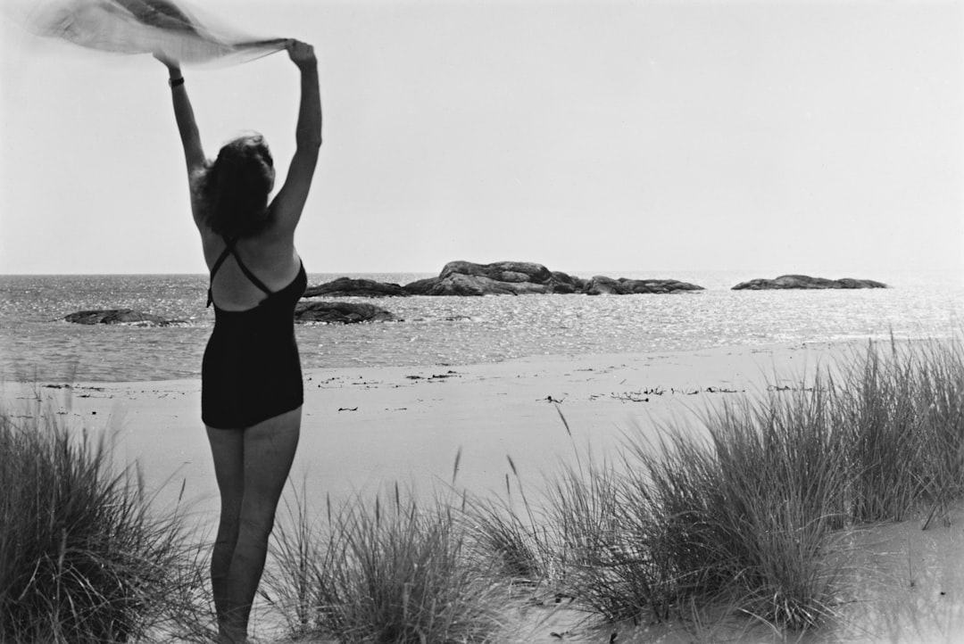 a woman in a bathing suit standing on a beach, G-30-10 Sommer Beskrivelse / Description: Forelegg for postkort. Dato / Date: ca. 1960 Sted / Place: ukjent / unknown Fotograf / Photographer: Normann Digital kopi av original / Digital copy of original: s/h papirpositiv Eier / Owner Institution: Nasjonalbiblioteket / National Library of Norway Lenke / Link: www.nb.no Bildesignatur / Image Number: blds_05924 https://www.flickr.com/photos/national_library_of_norway/9357322952/in/album-72157625154172158/