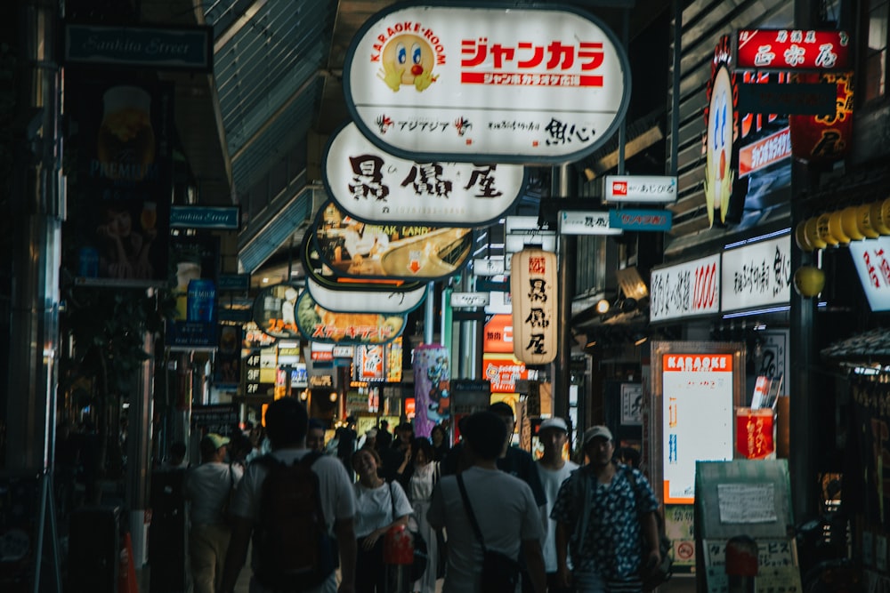 a group of people walking down a street at night