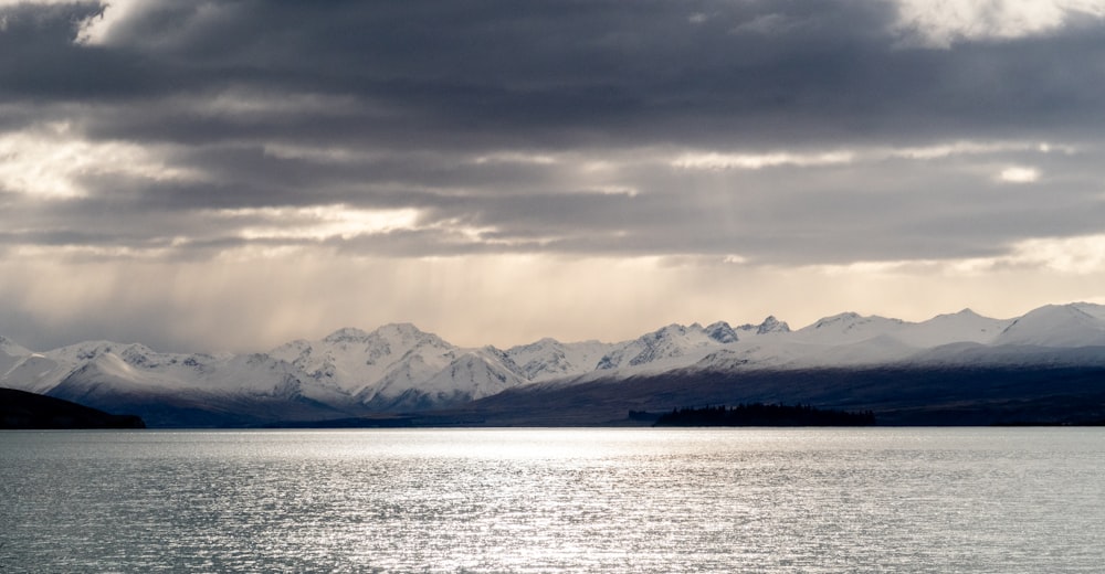 a large body of water with mountains in the background