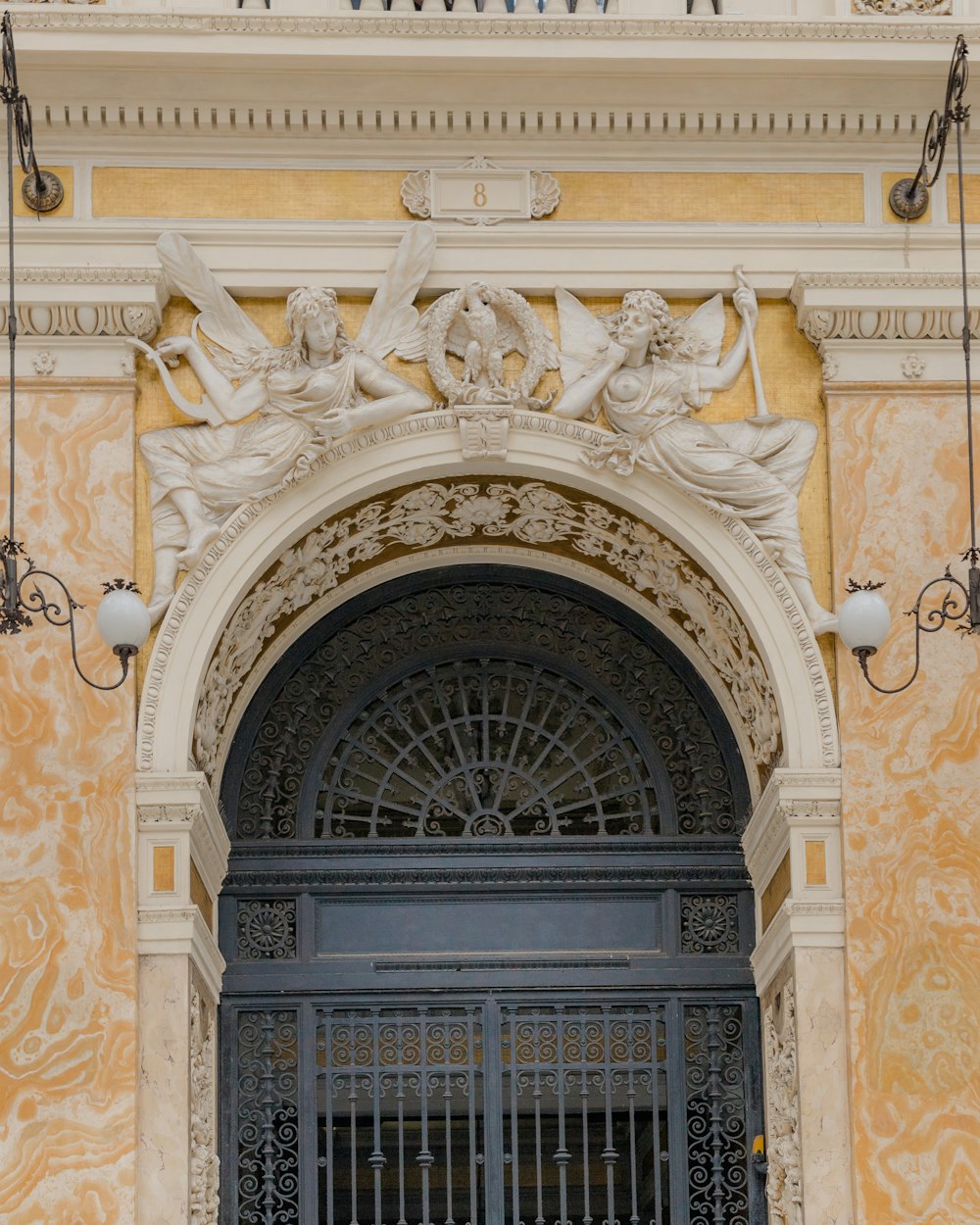 an ornate doorway with a clock above it