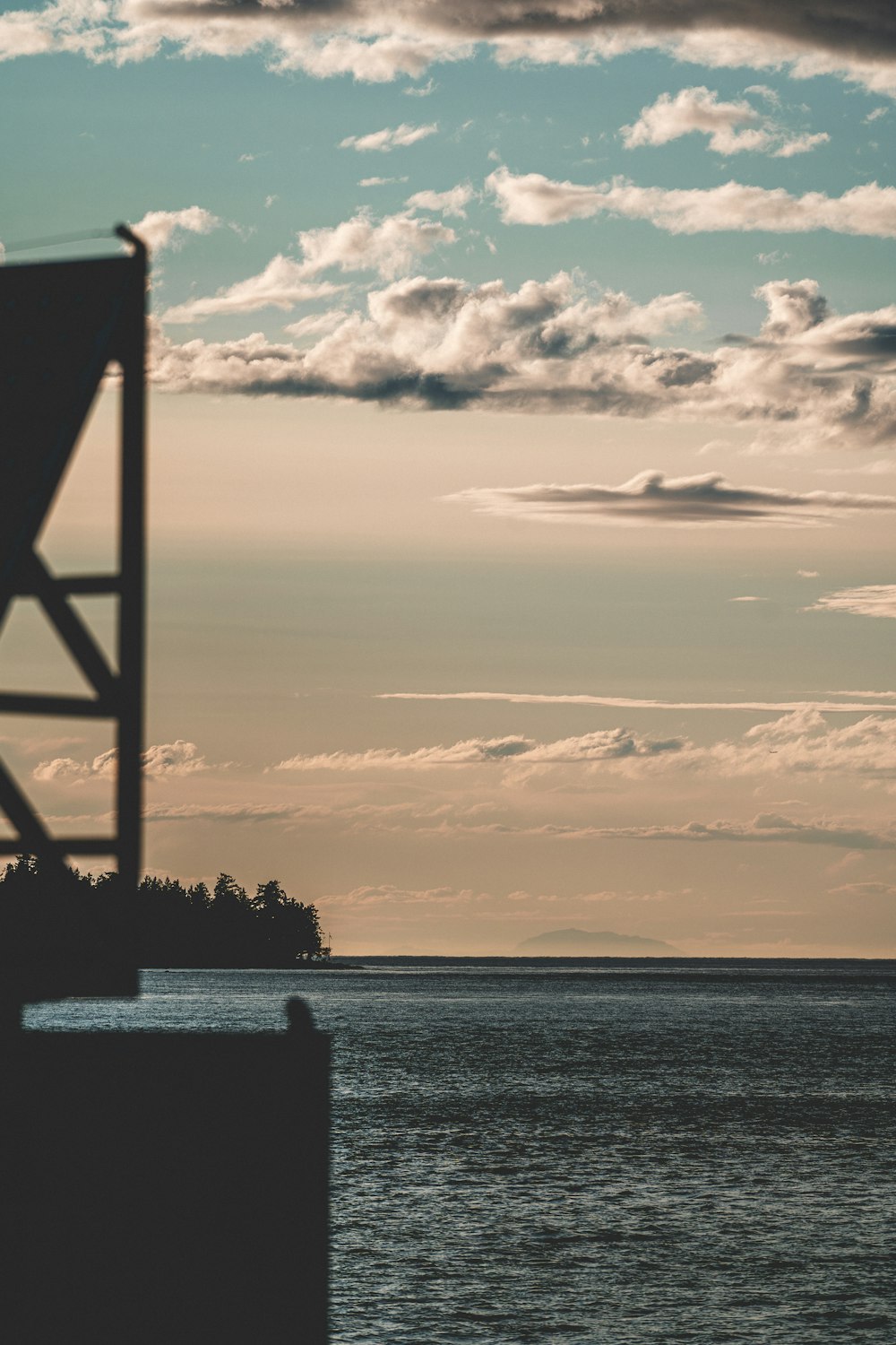 a large body of water under a cloudy sky