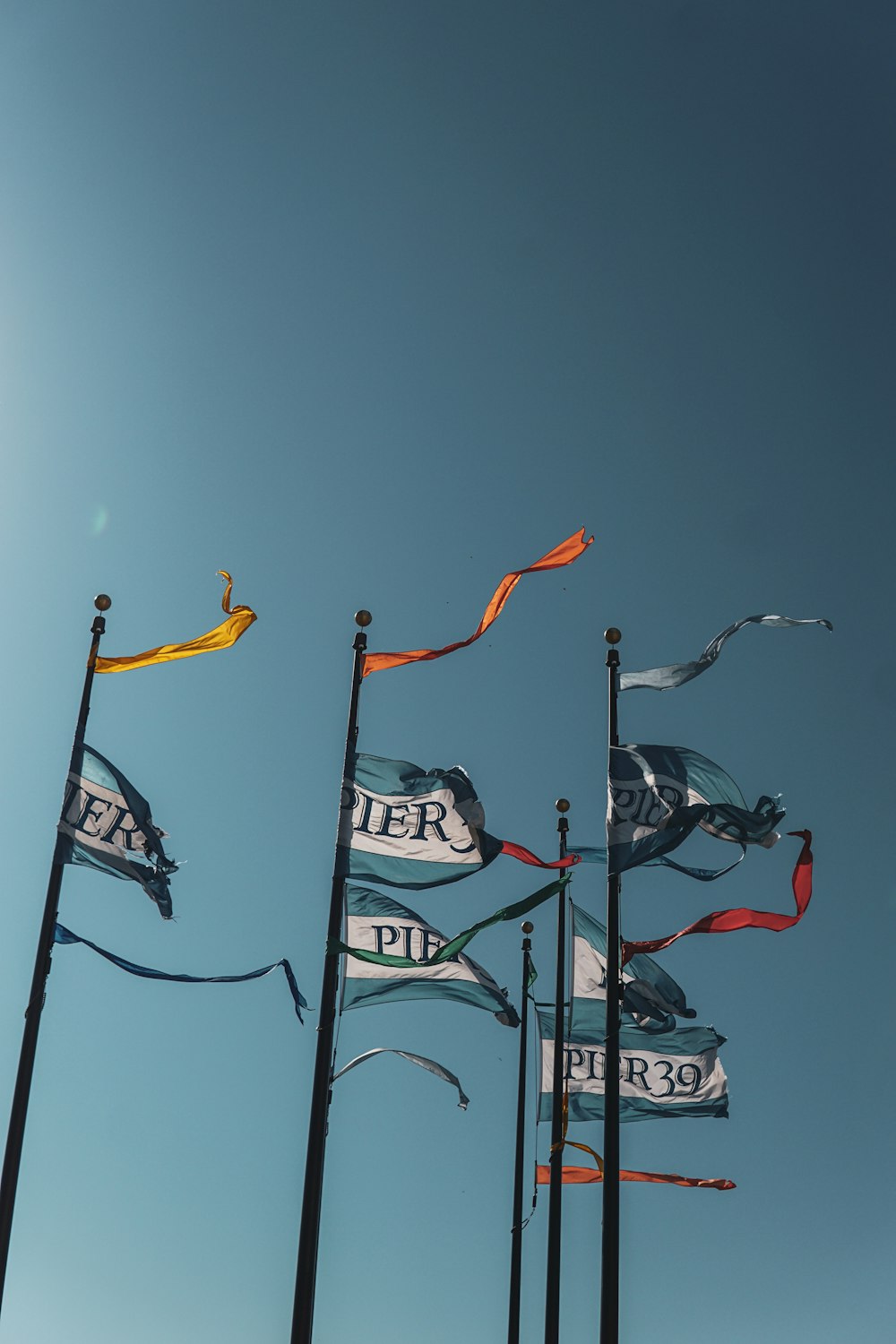 a bunch of flags that are flying in the air